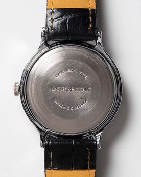 flatlay of the 1977 Timex Marlin M106, shown from the back, Accessories by Taylor Stitch