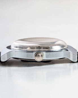 flatlay of the 1977 Timex Marlin M106, shown from the side, Accessories by Taylor Stitch