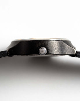 flatlay of the 1978 Timex Black Max, shown from the side, Accessories by Taylor Stitch