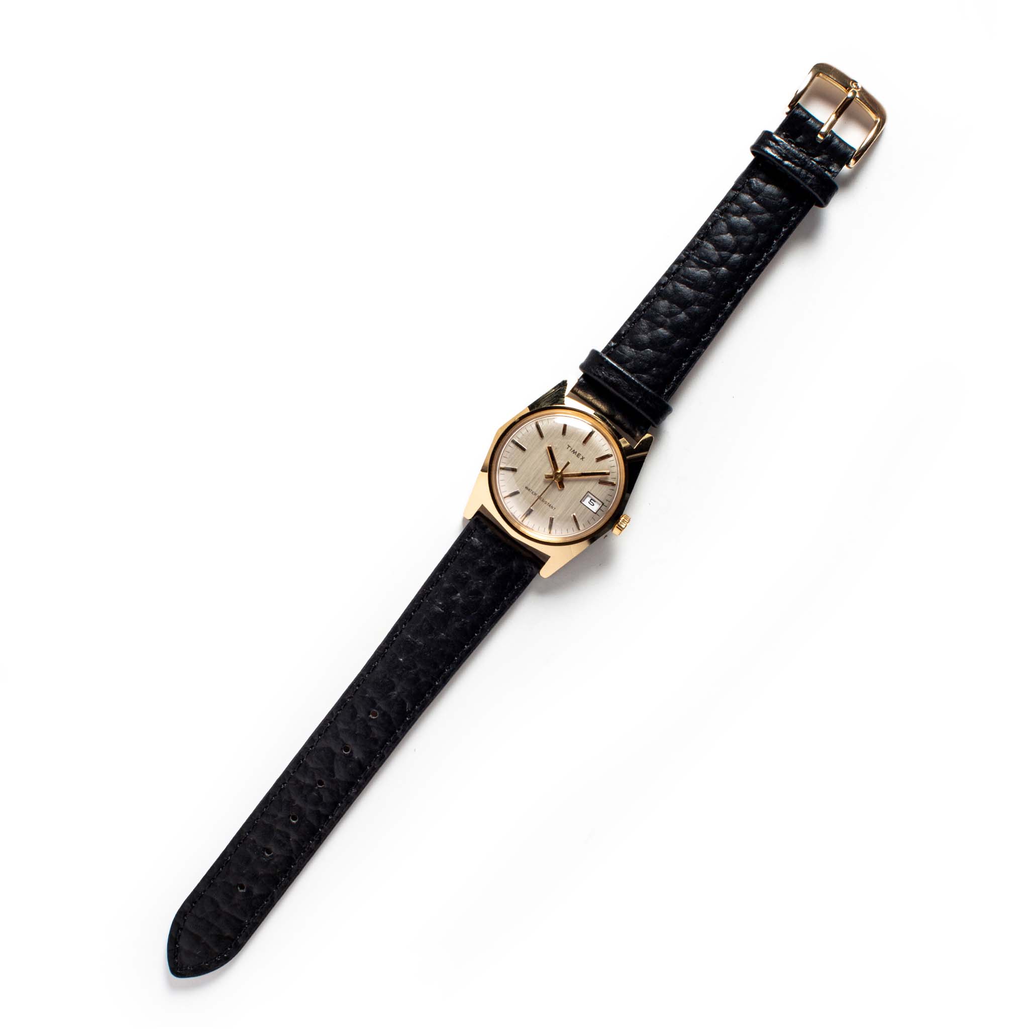 flatlay of the 1978 Timex Gold Marlin, Accessories by Taylor Stitch