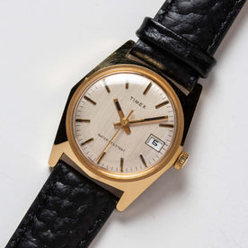 flatlay of the 1978 Timex Gold Marlin, shown close up