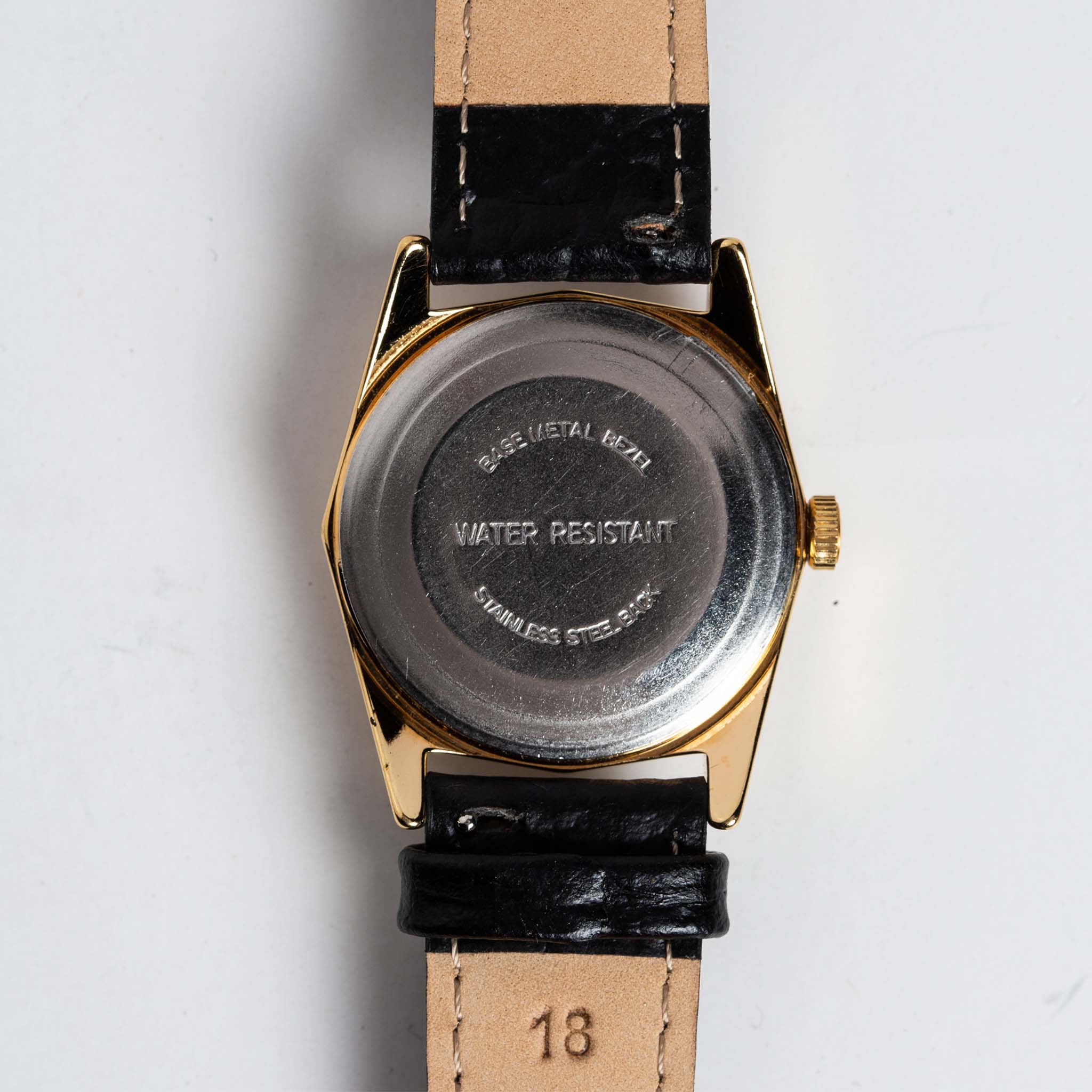 flatlay of the 1978 Timex Gold Marlin, shown from the back, Accessories by Taylor Stitch