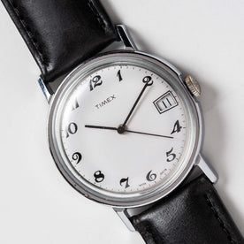 flatlay of the 1978 Timex Mercury, shown close up, Accessories by Taylor Stitch