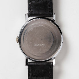 flatlay of the 1978 Timex Mercury, shown from the back, Accessories by Taylor Stitch