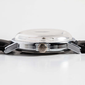flatlay of the 1978 Timex Mercury, shown from the side, Accessories by Taylor Stitch