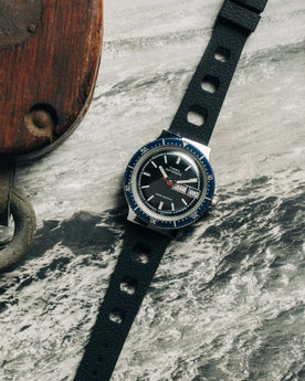 flatlay of the 1978 Timex Viscount M109 on a black and white photo of the ocean, Accessories by Taylor Stitch