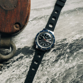 flatlay of the 1978 Timex Viscount M109 on a black and white photo of the ocean