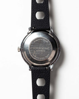flatlay of the 1978 Timex Viscount M109, shown from the back, Accessories by Taylor Stitch