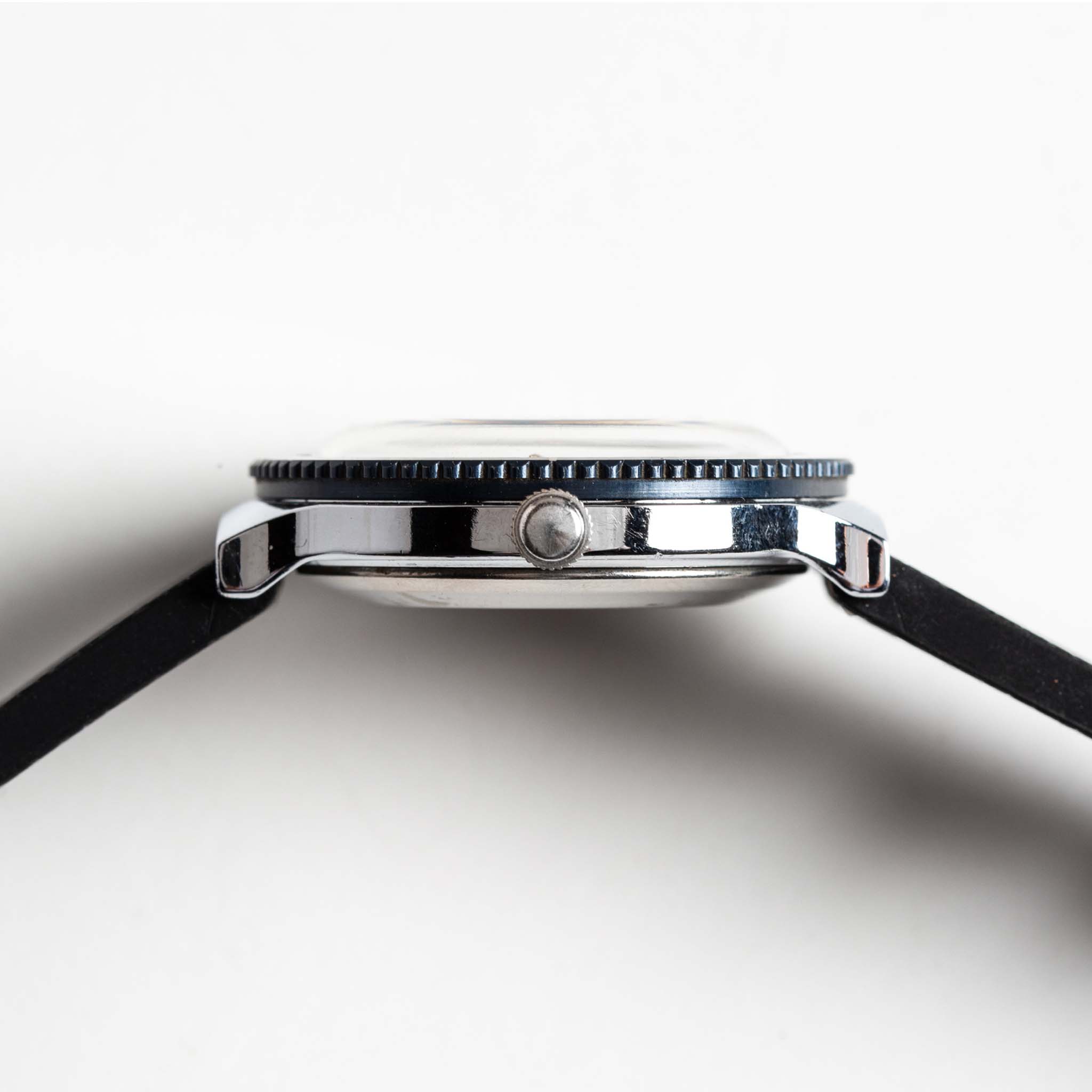 flatlay of the 1978 Timex Viscount M109, shown from the side, Accessories by Taylor Stitch