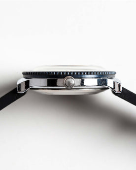 flatlay of the 1978 Timex Viscount M109, shown from the side, Accessories by Taylor Stitch