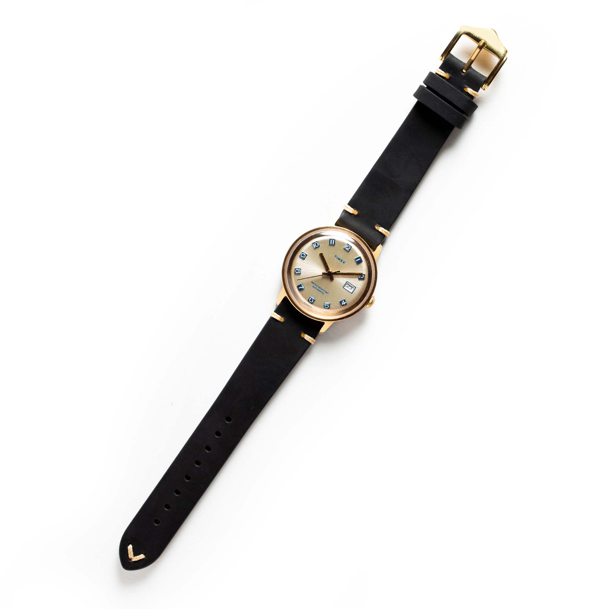 flatlay of the 1975 Timex Viscount, Accessories by Taylor Stitch