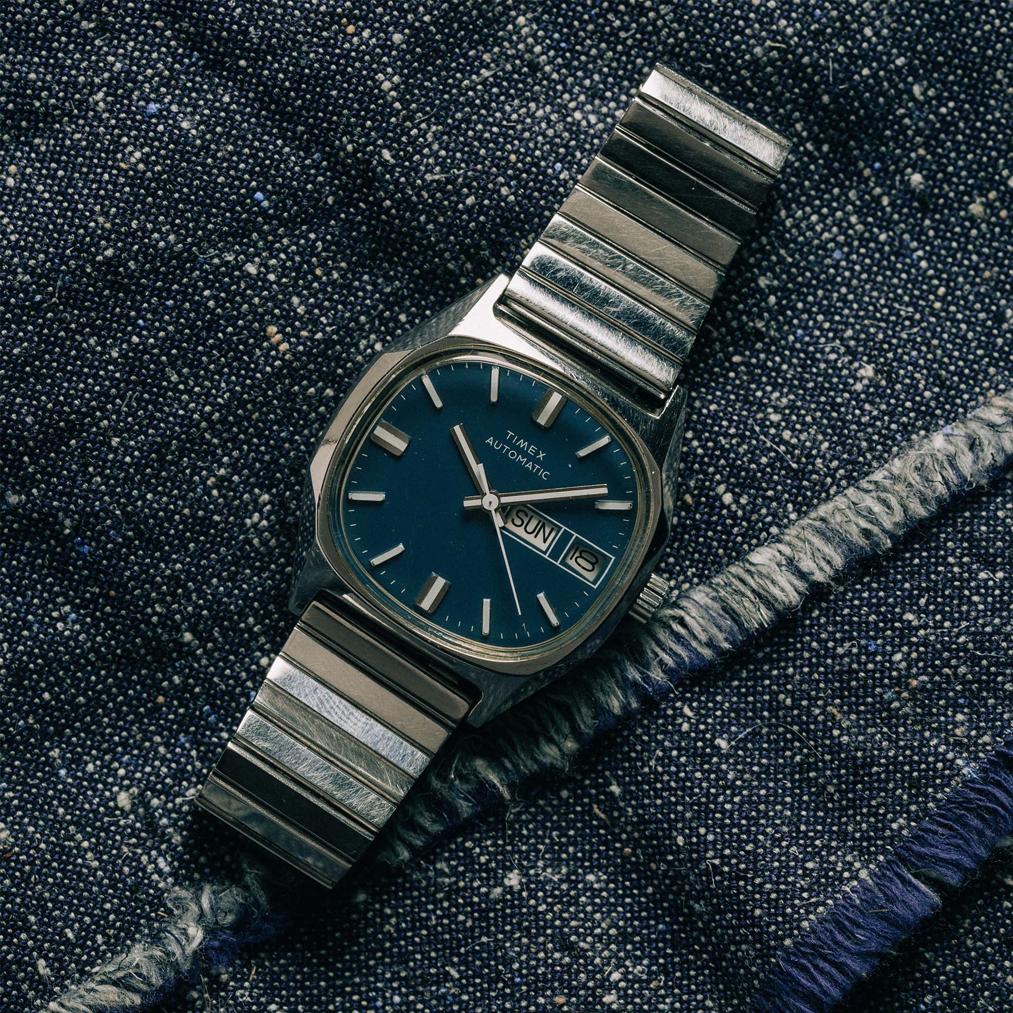 flatlay of the 1981 Timex Viscount, on a denim background, Accessories by Taylor Stitch