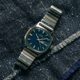 flatlay of the 1981 Timex Viscount, on a denim background, Accessories by Taylor Stitch