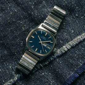 flatlay of the 1981 Timex Viscount, on a denim background
