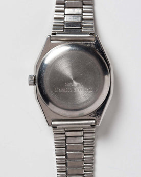 flatlay of the 1981 Timex Viscount, shown from the back, Accessories by Taylor Stitch
