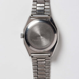flatlay of the 1981 Timex Viscount, shown from the back, Accessories by Taylor Stitch