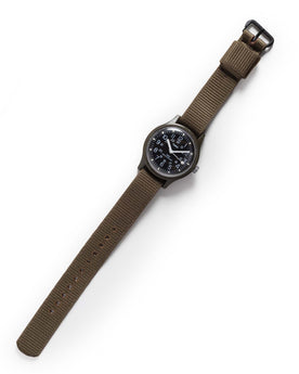 flatlay of the 1991 Timex Camper, Accessories by Taylor Stitch