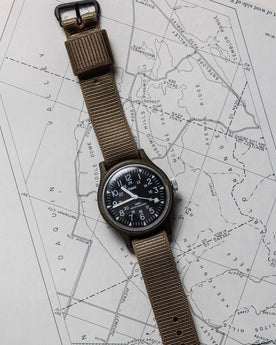 flatlay of the 1991 Timex Camper on a map, Accessories by Taylor Stitch