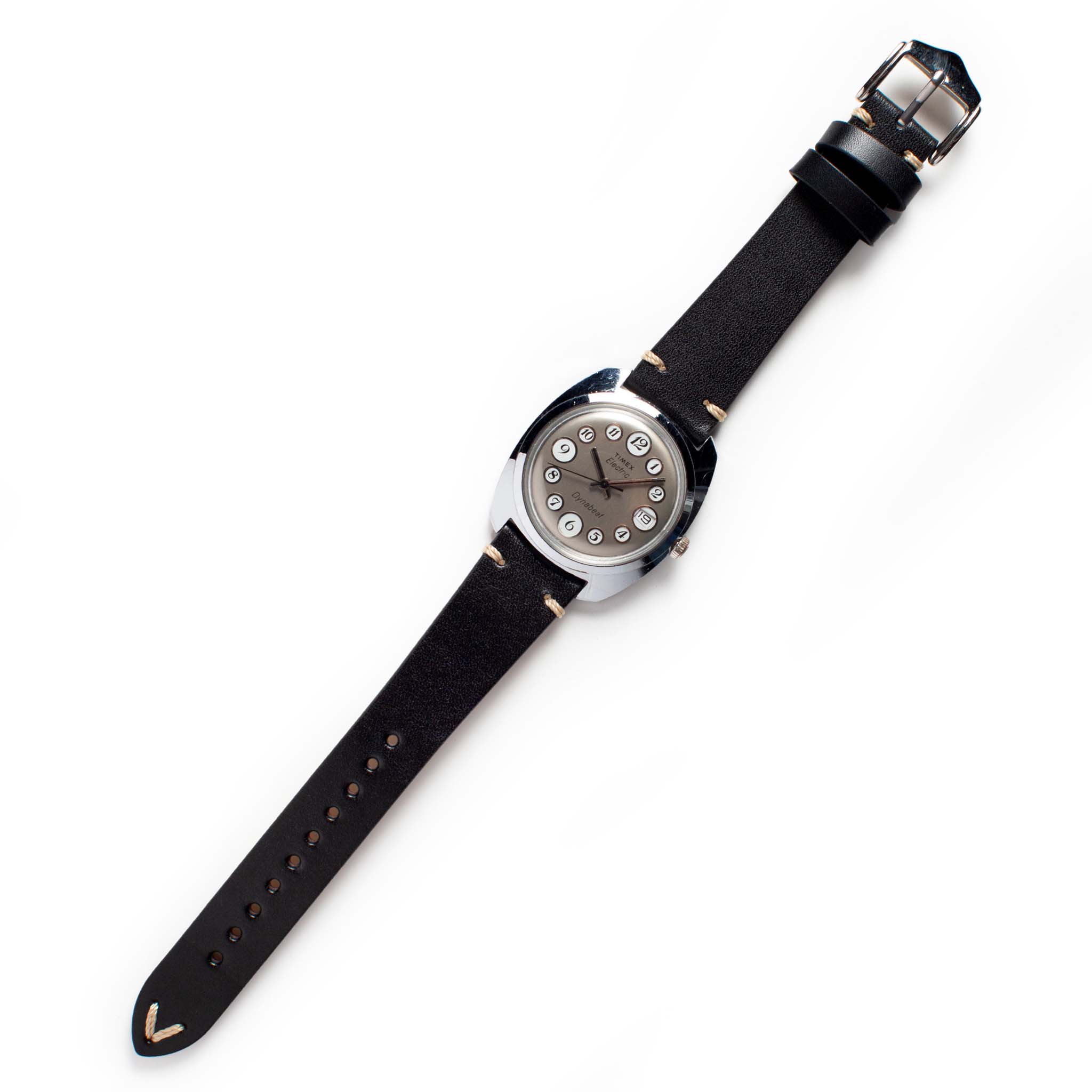 flatlay of the 1975 Timex Electric Dynabeat "Rotary", Accessories by Taylor Stitch