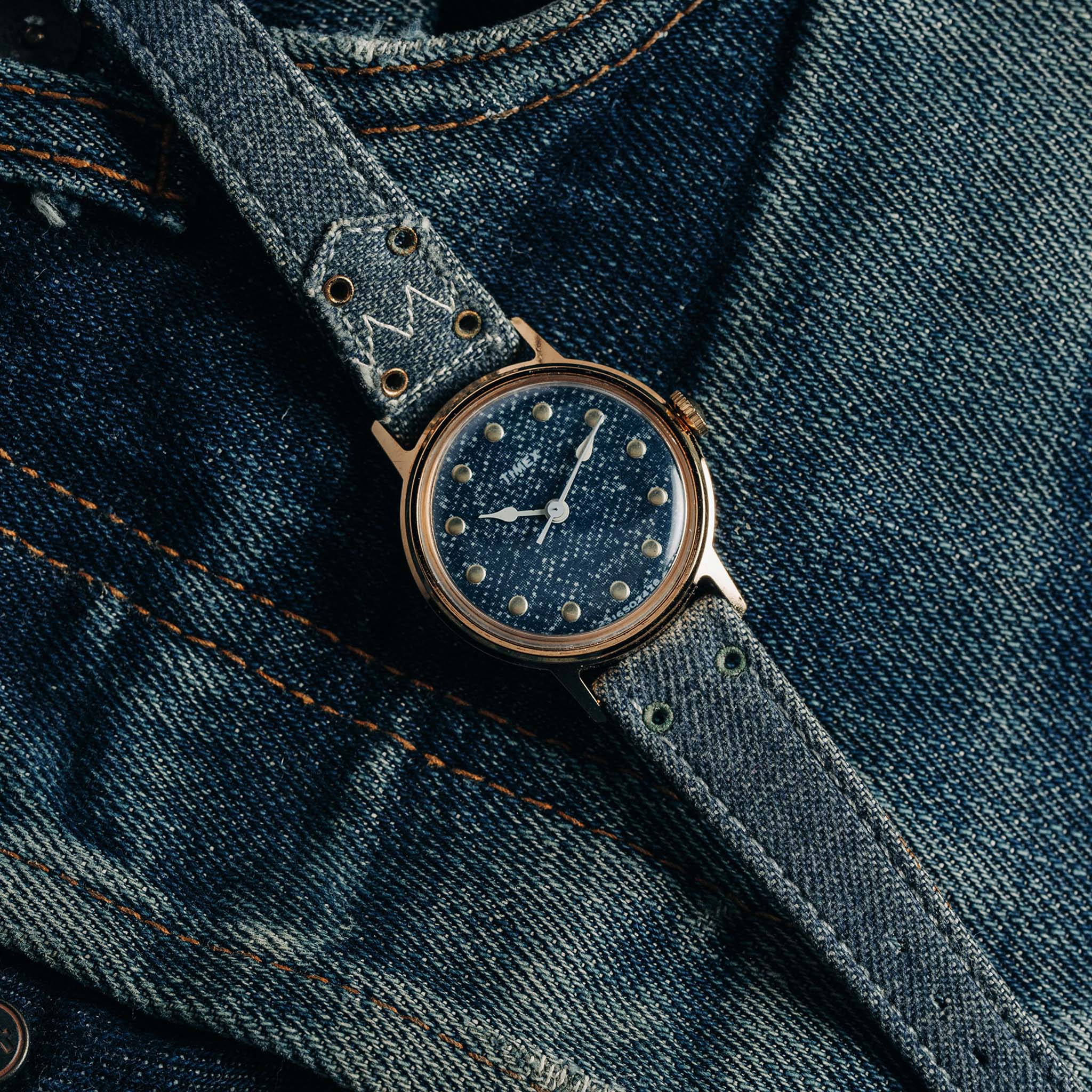 flatlay of the 1978 Timex Mercury "Denim", shown on a pair of jeans, Accessories by Taylor Stitch
