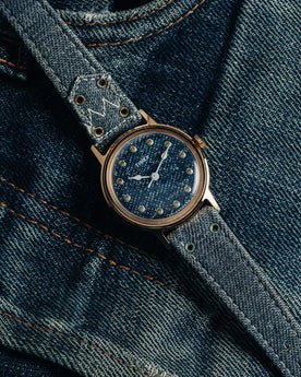 flatlay of the 1978 Timex Mercury "Denim", shown on a pair of jeans, Accessories by Taylor Stitch