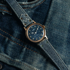 flatlay of the 1978 Timex Mercury "Denim", shown on a pair of jeans