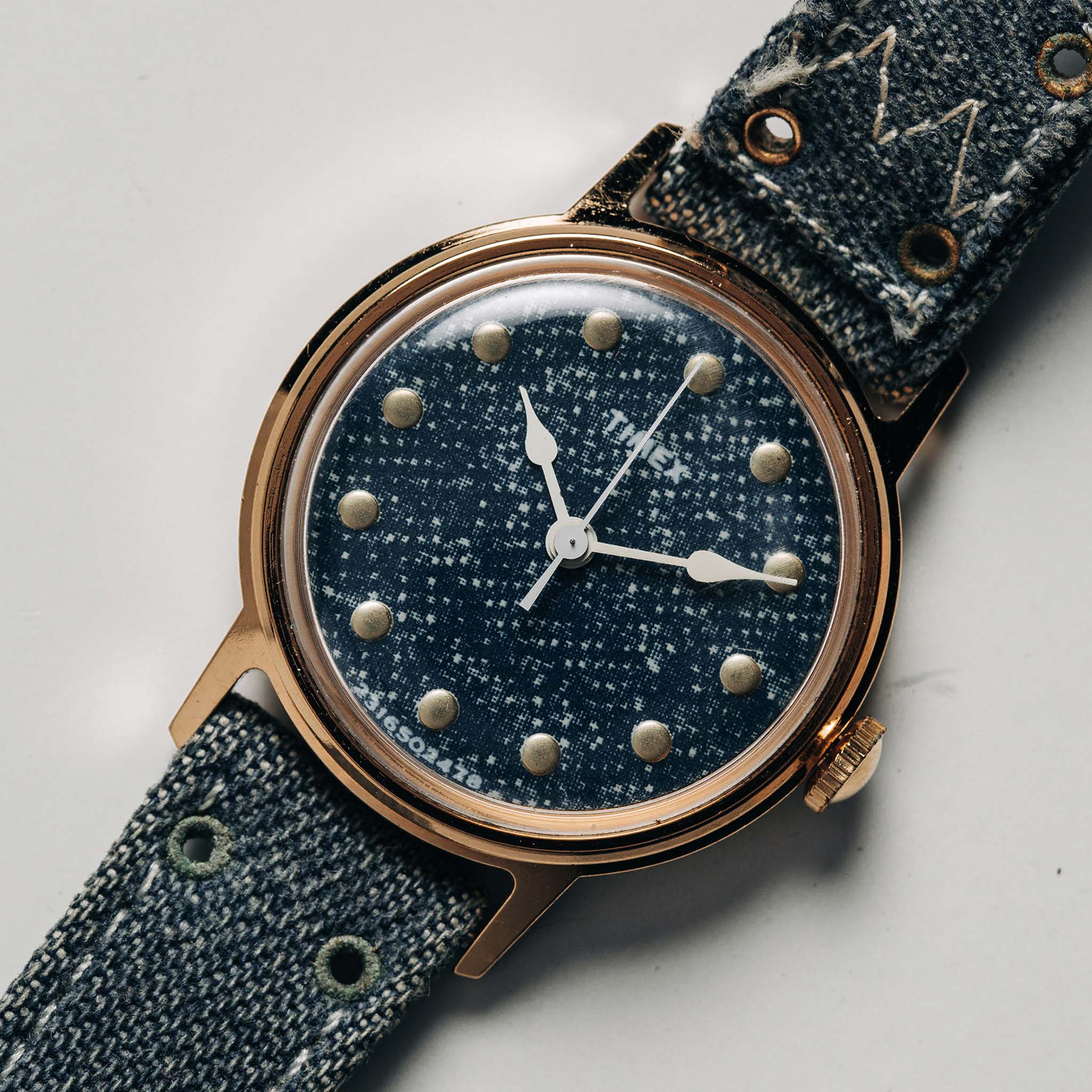 flatlay of the 1978 Timex Mercury "Denim", shown close up, Accessories by Taylor Stitch