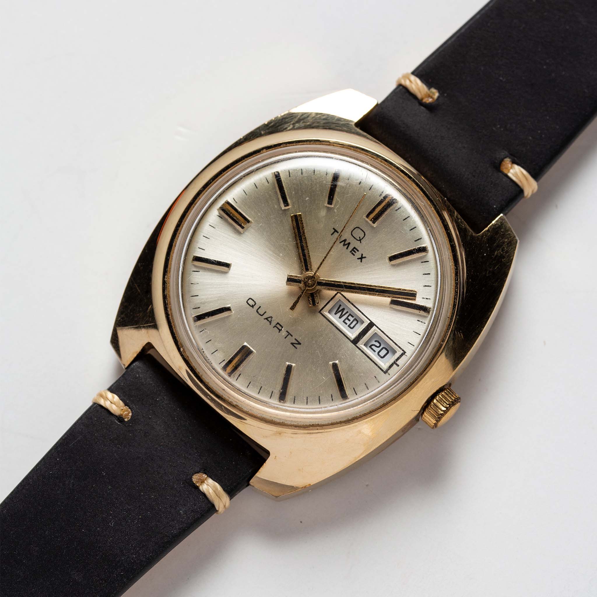 flatlay of the 1978 Timex Q Quartz, shown close up, Accessories by Taylor Stitch
