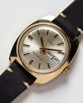 flatlay of the 1978 Timex Q Quartz, shown close up, Accessories by Taylor Stitch