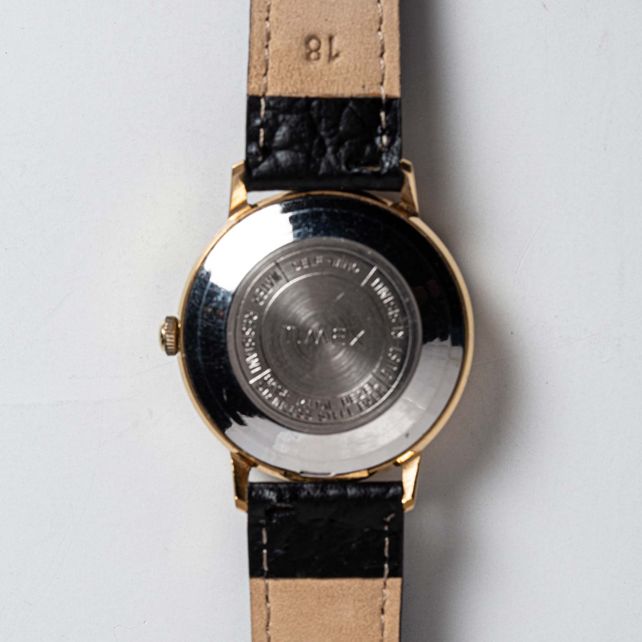 Back of Flat lay of Timex 1970 Viscount, Accessories by Taylor Stitch