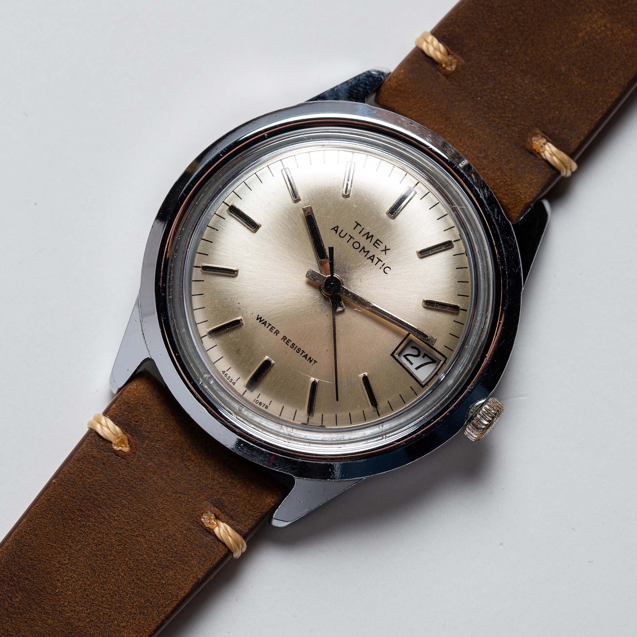 flatlay of  the 1978 Timex Viscount M108, shown close up, Accessories by Taylor Stitch
