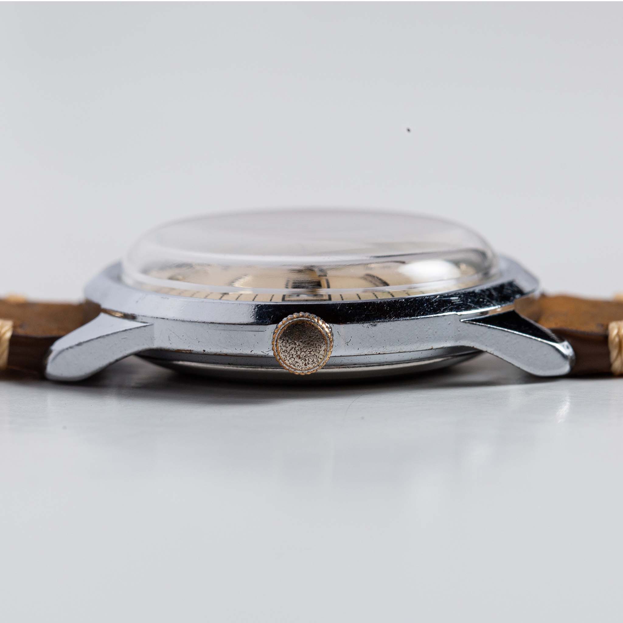 flatlay of the 1978 Timex Viscount M108, shown from the side, Accessories by Taylor Stitch