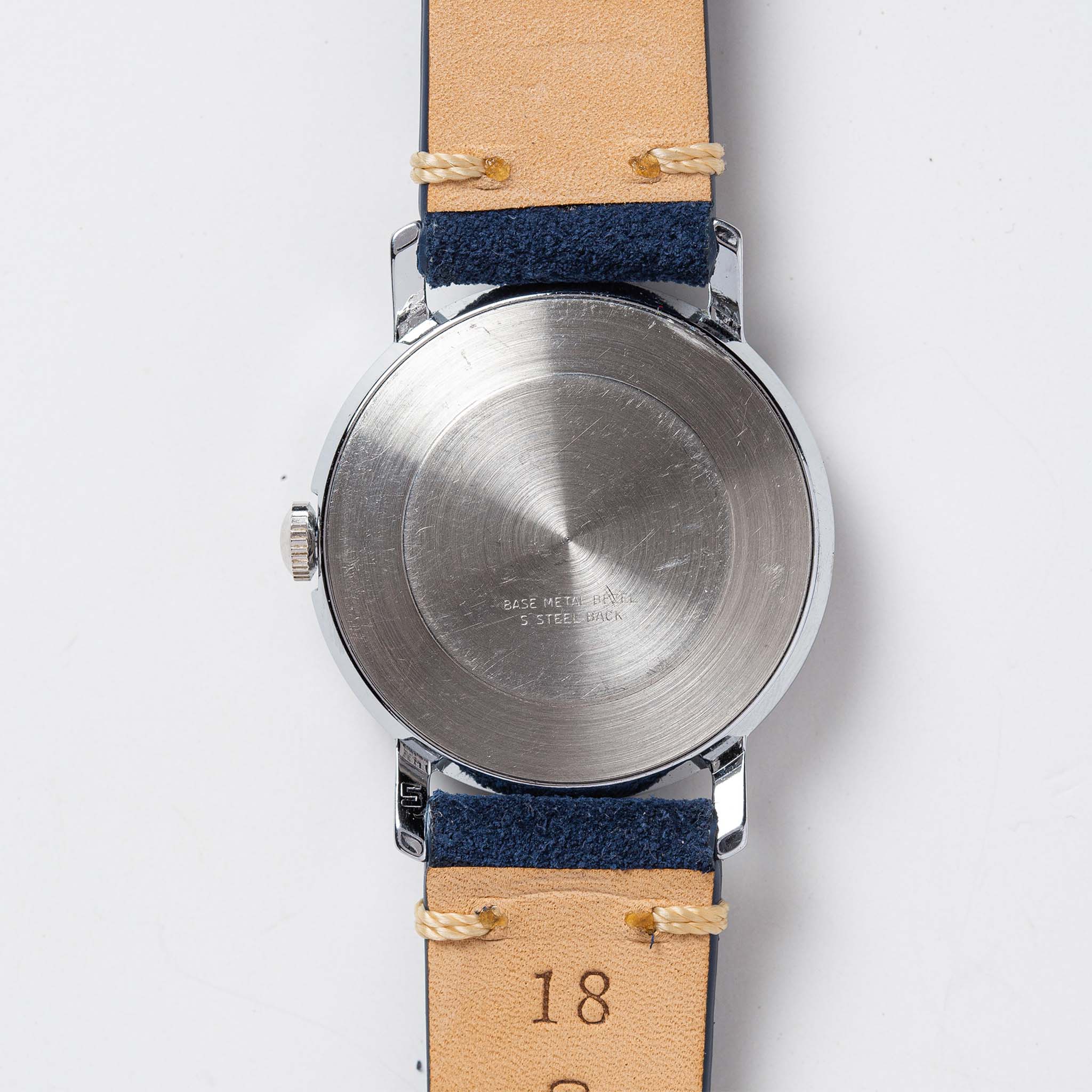 flatlay of the 1974 Timex Viscount M31, showing the back, Accessories by Taylor Stitch