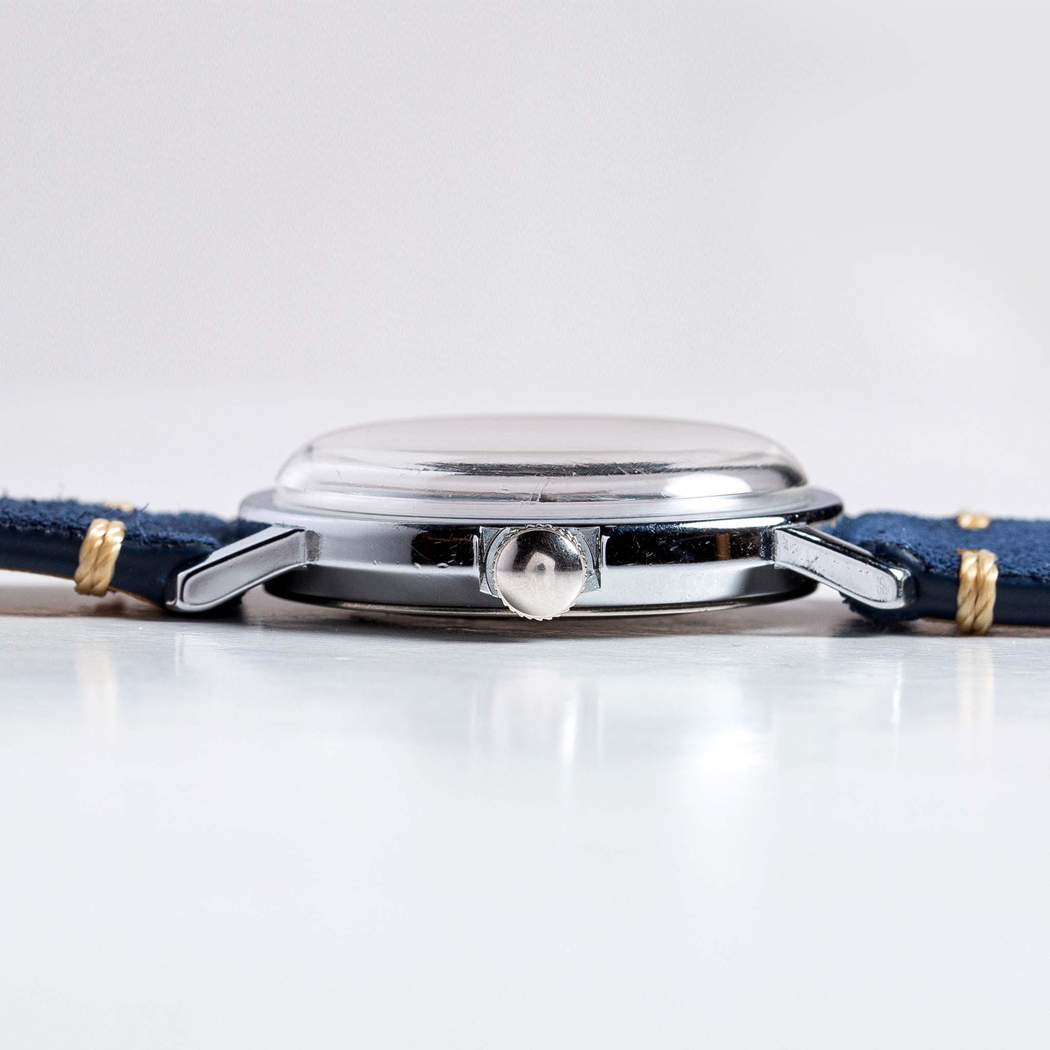 flatlay of the 1974 Timex Viscount M31, from the side, Accessories by Taylor Stitch