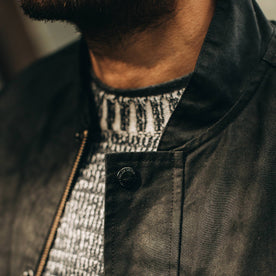 fit model wearing The Bomber Jacket in Black Dry Wax, button close up