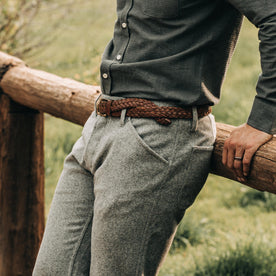 fit model wearing The Camp Pant in Heather Grey Wool—sitting on fence
