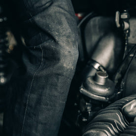 fit model wearing The Democratic Jean in Black Over-dye Selvage, knee close up
