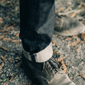 fit model wearing The Democratic Jean in Black Over-dye Selvage, cuffed bottom