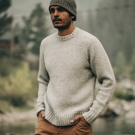 fit model wearing The Fisherman Sweater in Heather Ash, hands in pockets