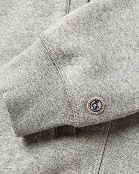 material shot of The Heavy Bag Bomber in Heather Grey Fleece's cuff with TS logo embroidery, Knits by Taylor Stitch