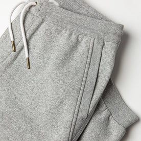 flatlay of The Heavy Bag Pant in Heather Grey Fleece with diagonal reinforced hand pocket visible
