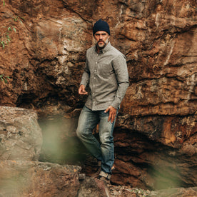 our fit model wearing The Jack in Charcoal Donegal—looking right next to boulders