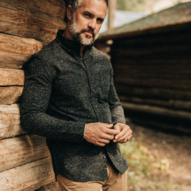 our fit model wearing The Jack in Coal Donegal—leaning against cabin