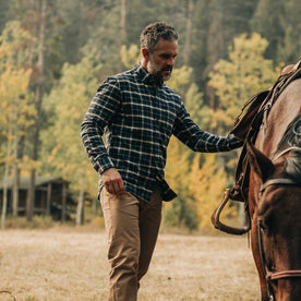 fit model wearing The Jack in Brushed Green Plaid, petting horse