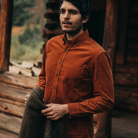 fit model wearing The Jack in Rust Cord, holding sweater