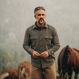 our fit model wearing The Leeward Shirt in Houndstooth in front of horses