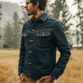 fit model wearing The Long Haul Jacket in Cone Mills Reserve Selvage, looking left