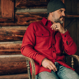 our fit model wearing The Maritime Shirt Jacket in Clifford Red—sitting, looking right
