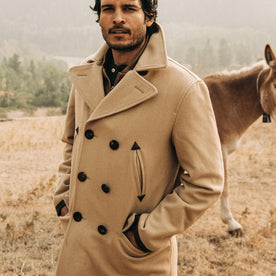 fit model wearing The Mendocino Peacoat in Camel Wool, standing near donket