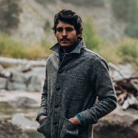 our fit model wearing The Scarf in Navy Baby Yak—standing near creek